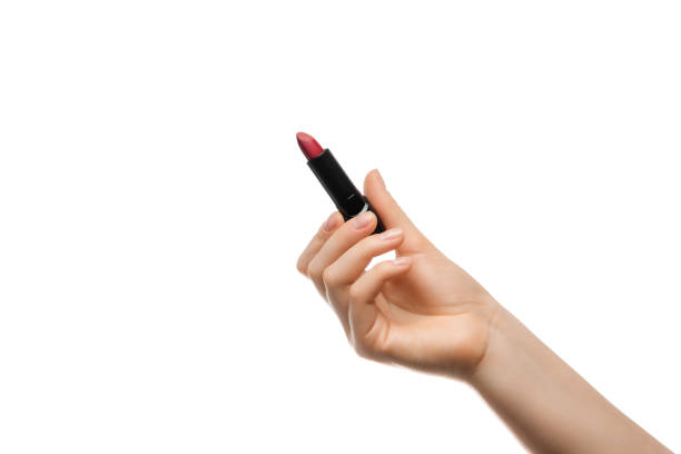 istock Red lipstick in a woman's hand on a white background, isolated. 1386289994