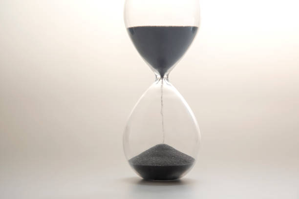istock Hourglass on a light background. Time is money. Business solutions in time. 1386291374