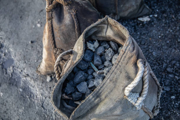 Coal and coke in a hessian sack - old fashion form of storage and transportation of fuel. Coal and coke in a hessian sack - old fashion form of storage and transportation of fuel. coke coal stock pictures, royalty-free photos & images