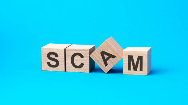 istock SCAM word written in wooden blocks on blue background, concept 1386300136