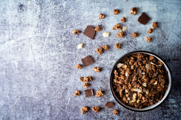 Chocolate nuts oatmeal granola with chocolate slices in a bowl Chocolate nuts oatmeal granola with chocolate slices in a bowl. the toning. selective focus muesli stock pictures, royalty-free photos & images