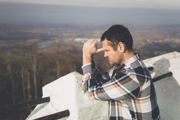 istock A thinking man leaning his head to his hands at the mountain viewpoint 1386303851