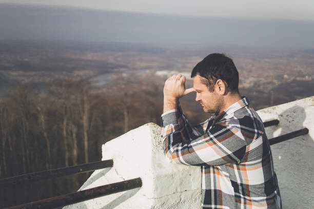 istock A thinking man leaning his head to his hands at the mountain viewpoint 1386303914