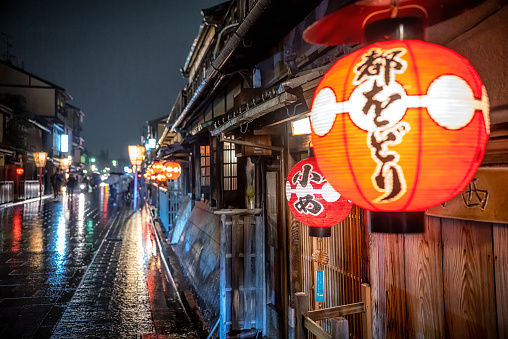 march 30, 2019 - Kyoto, Japan: street in Gion district at night with people and illuminated restaurant buildings