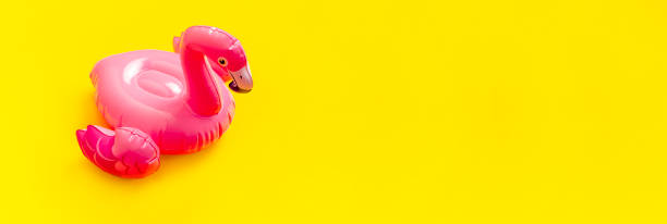 istock Creative summer beach concept. Inflatable pink mini flamingo on yellow background, pool float party. Flat lay, copy space. Flamingo Trend Inflatable Toy. Summer background. Layout for design 1386306228