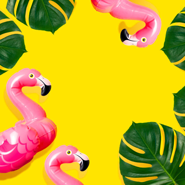 istock Creative summer beach concept. Inflatable pink mini flamingo and tropical leaf monstera on yellow background, pool float party. Flat lay copy space. Flamingo Trend Inflatable Toy. Summer background 1386306233