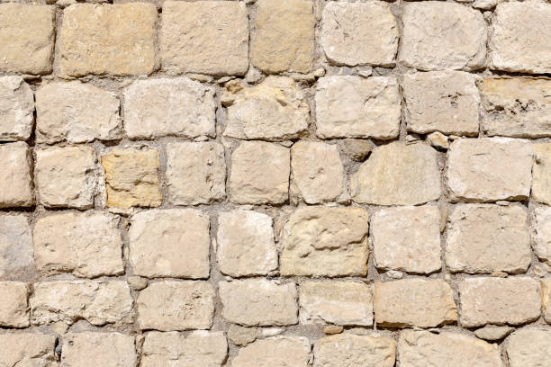 istock The background old beige wall made of natural stone 1386306772