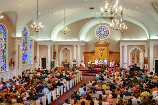 Hundreds of people filling the pews at a Catholic Church