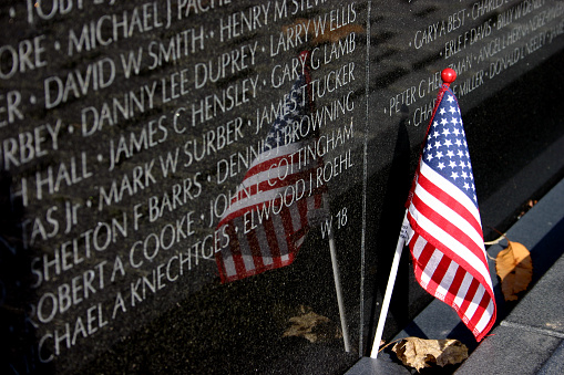 Section of the Vietnam Veterans Memorial with a flag