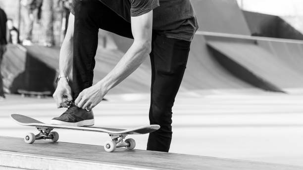 istock Unrecognizable skateboarder lacing skating shoes 1386308483