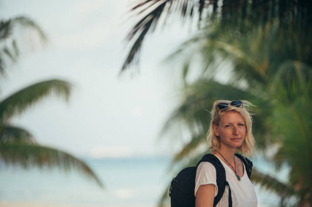 istock A woman surrounded by palm trees 1386314005