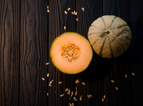 sweet melon on a dark background small delicious beautiful melon, both whole and in pieces and folded for eating love it Ukraine