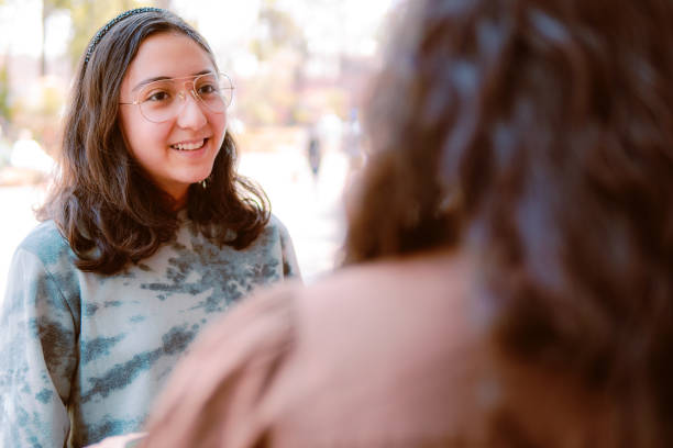 istock Smiling young woman talking to someone 1386332488