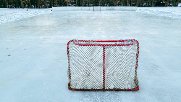 Red hockey net on outside ice rink A bright red hockey net on a outdoors ice rink ice hockey net stock pictures, royalty-free photos & images