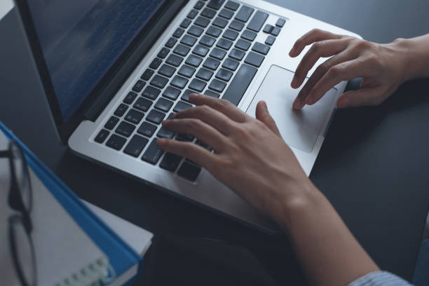 istock Business woman working on laptop computer 1386335559