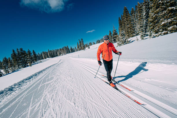 Cheerful Cross-Country Skier Skiing Along a Groomed Trail on a Clear, Sunny "Blue Bird" Day in the Grand Mesa National Forest in Colorado stock photo