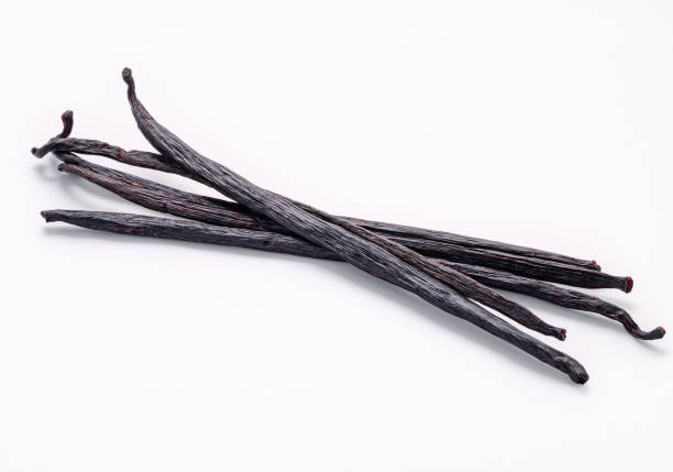 istock Dried vanilla sticks and orchid flower isolated on white background. 1386357390