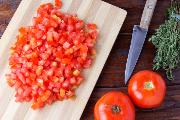 istock Raw chopped and diced tomatoes cubes over rustic wooden table 1386358005