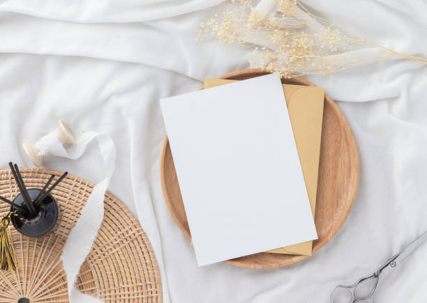 istock Blank greeting card invitation Mockup 5x7 on Brown envelope with dried flowers on pastel green background, flat lay, mockup 1386367613