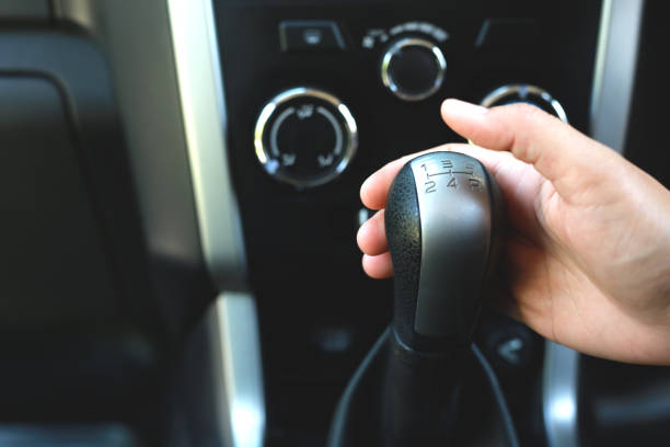 mujer sosteniendo un engranaje en un automóvil para una prueba de primer plano - car gearshift change engine fotografías e imágenes de stock