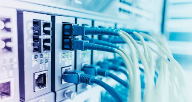 istock Fiber Optical cables connected to an optic ports and Network cables connected to ethernet ports 1386367770