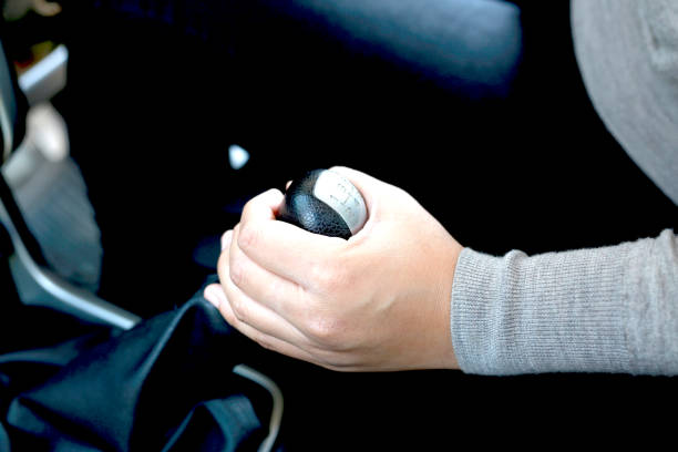 Woman holding a gear in a car for a close-up test stock photo