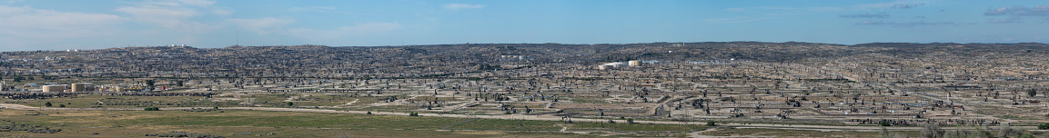 A panoramic view of the Kern River Oil Field. This oil field has the densest distribution of oil wells in California. Near Bakersfield, California, USA.