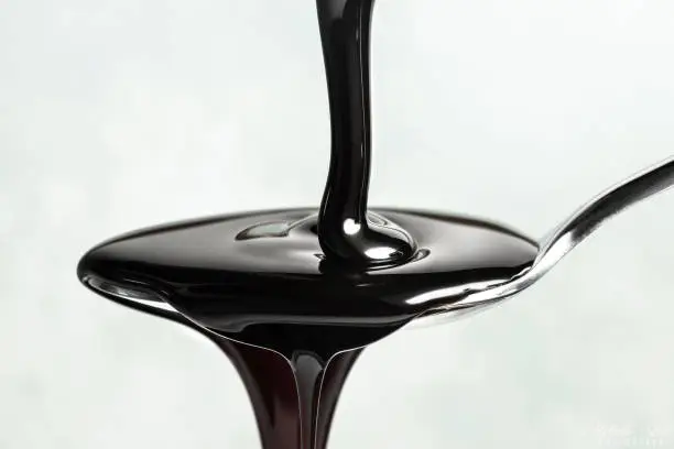 Molasses Poured on a Spoon