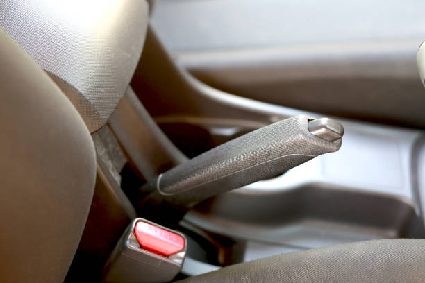 istock A woman pulls the handbrake in an automatic transmission car. 1386370797