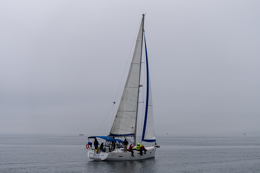Seattle, Washington, USA - January 15, 2022: The winter Snowbird Regatta hosted by the The Shilshole Bay Yacht Club in Seattle, Washington races on a clear winter day.