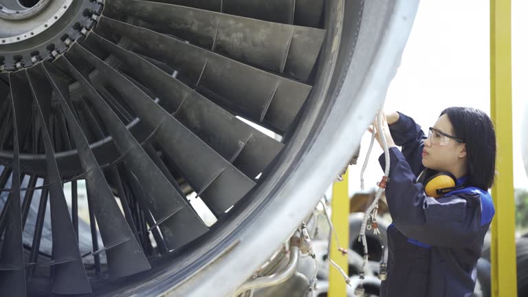 4K Female Aircraft Engineer Working On Jet Engine In Airport