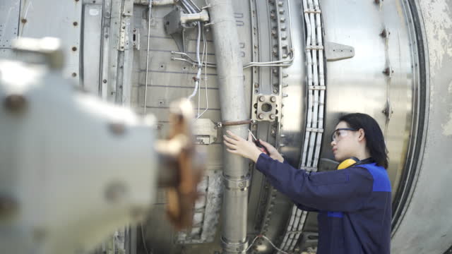 4K Female Aircraft Engineer Working On Aircraft Engine