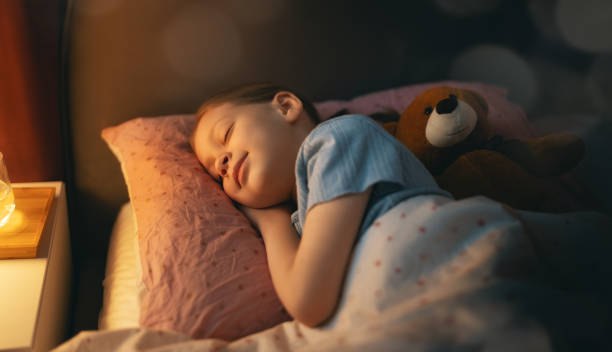 istock child is sleeping in the bed 1386376940