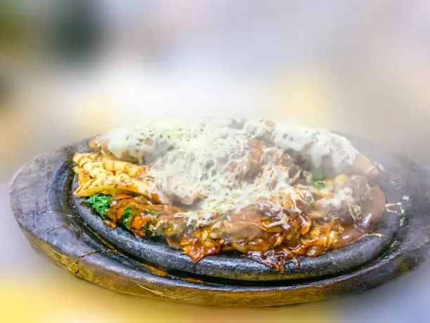 A very Yammy vegetable Sizzler with corn cutlets , served very hot in wooden plate