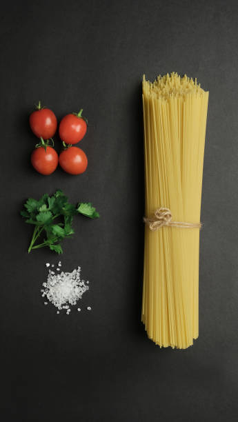 istock Pasta with tomato sauce, pasta with tomato parsley salt tomato, top view 1386387925