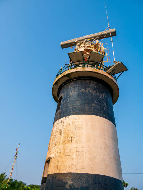 istock Lighthouse in vertical alignment,  designed to emit light from a system of lamps and lenses 1386391958