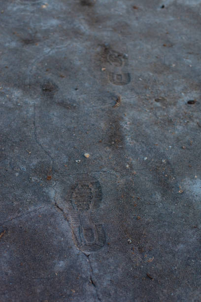istock Gray background with cracks and hollows 1386394789