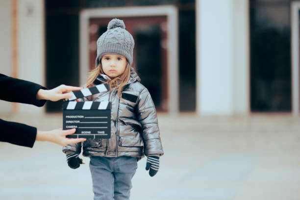 istock Actor Child Looking at the Camera Filming a Commercial 1386398167