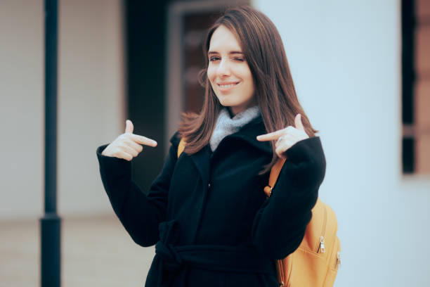 istock Self-Confident Smiling Girl Pointing to herself 1386398225