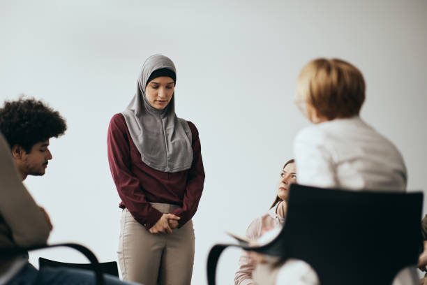 istock Anxious Middle Eastern woman talking about her mental health issues during group therapy meeting. 1386401054