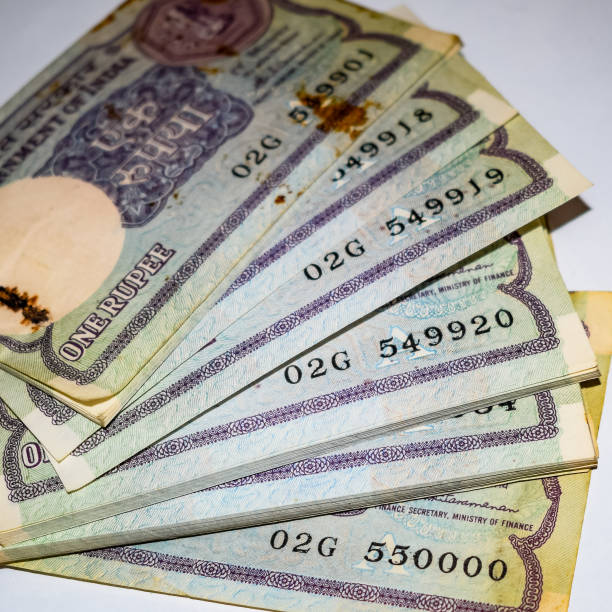 istock Old One Rupee notes combined on the table, India money on the rotating table. Old Indian Currency notes on a rotating table, Indian Currency on the table 1386401201