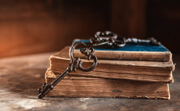istock old vintage keys on an old battered book, wooden background. 1386403590