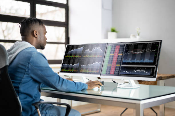 istock Stock Market Analyst At Office Desk 1386403677
