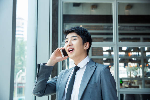 istock businessman standing in front of glass windows 1386404699