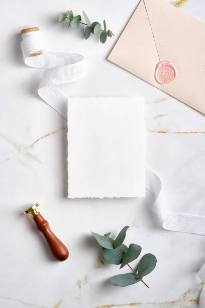 istock Wedding invitation card mockup, pink envelope, wax seal stamp, eucalyptus branches, ribbon on marble desk. Elegant wedding stationery set. Flat lay, top view, copy space. 1386404907