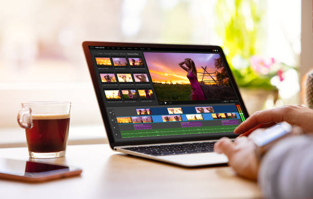 istock Woman editing video footage on laptop 1386405688