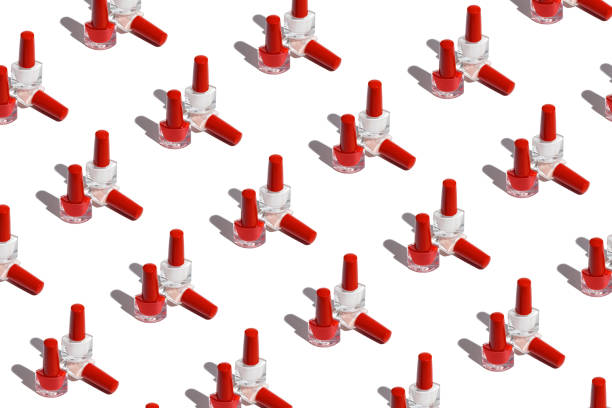 istock Repetitive pattern with nail polish bottles on white background. 1386405757