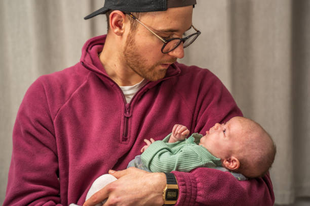 istock Father lovingly holding newborn daughter 1386406092