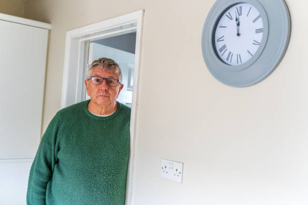 istock Senior Caucasian man peering around doorway 1386406314