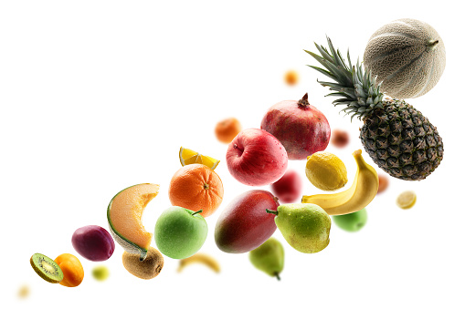 Fresh fruits levitate on a white background.